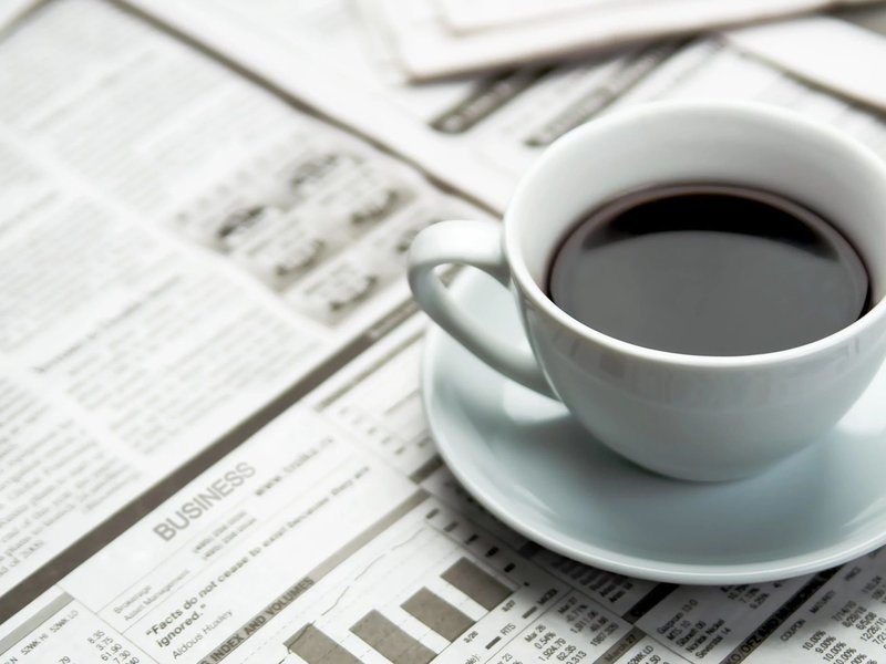 coffee cup on a table full of newspapers from Carpet Depot Inc in the North Hollywood, CA area